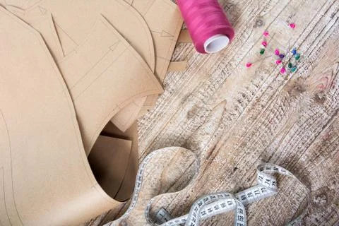 Objects for sewing clothes. Roulette, coil, and patterns on the table Stock Photos