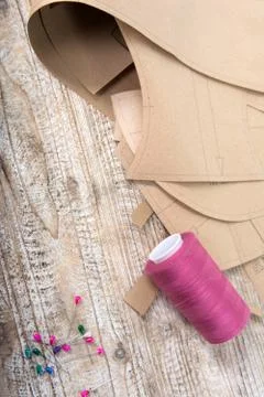 Objects for sewing clothes. Roulette, coil, and patterns on the table Stock Photos