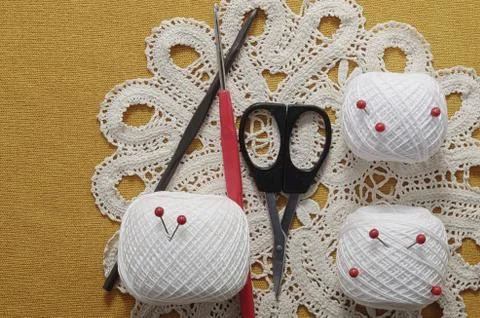 Objects for sewing. Scissors and pins. Hanks thread on mat. Pins Stock Photos