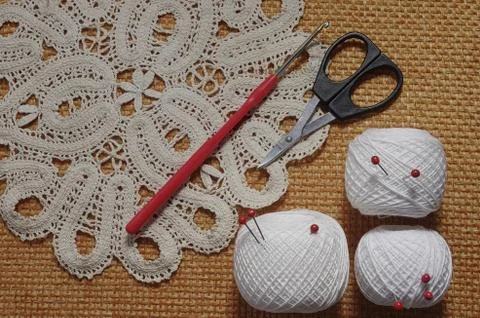 Objects for sewing. Scissors and pins. Hanks thread on mat. Pins Stock Photos