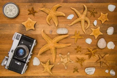 The objects of the traveler: a compass, a camera and the inhabitants of the s Stock Photos