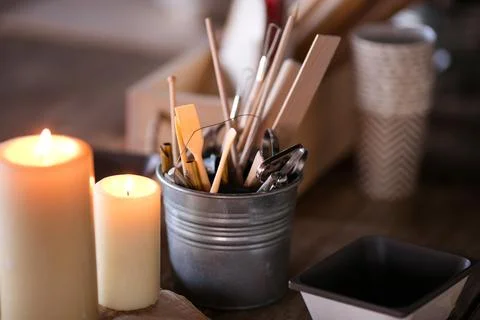 Objects for working with clay, stacks, sticks, brushes standing in a bucket Stock Photos