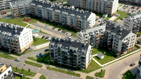 Oblique aerial drone tracking over suburban apartments with lawns, balconies Stock Footage 312593335