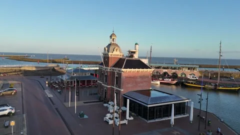 Oblique close approach to harbormaster building with sea beyond Stock Footage 331842418