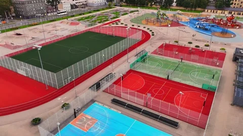 Oblique drone view of Centra Sporta Kvartāls in Riga, showing a football pitch Stock Footage 346310918