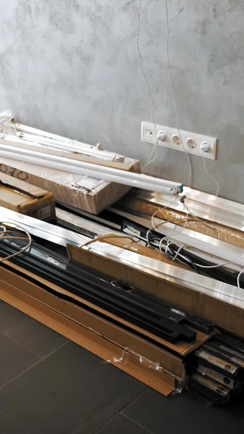 Oblong fluorescent lamps lie in boxes on the floor in a warehouse. white Stock Footage 321648765