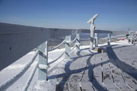 An observation deck in the mountains. Snow-capped mountains. Stock Photos