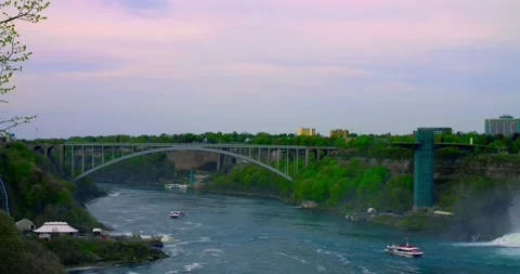 Observation deck overlooking American Falls at midday, mist drifting over stone Stock Footage 312579843