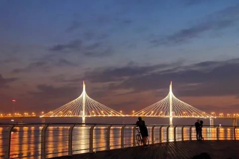 Observation deck on the shore with a view of the cable-stayed bridge and suns Stock Photos