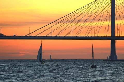 Observation deck on the shore with a view of the cable-stayed bridge and suns Stock Photos