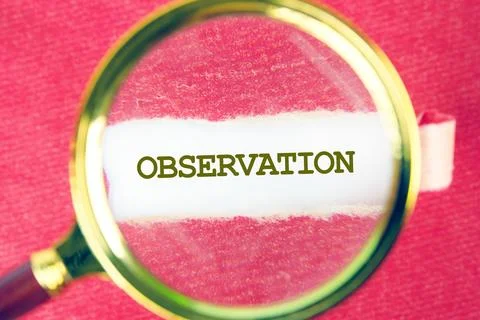 OBSERVATION word was found using a magnifying glass under a piece of paper Stock Photos