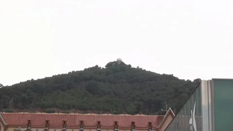 Observatory hill high mountain peak overcast trees roof Barcelona Stock Footage 327217315