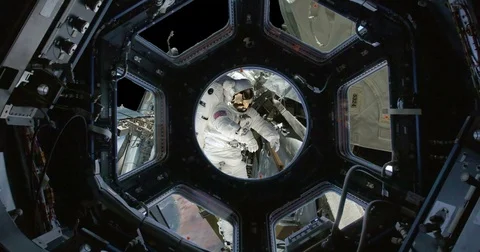 Observing Astronaut Fixing ISS Through Space Station Windows, 4K Stock Footage 76417110