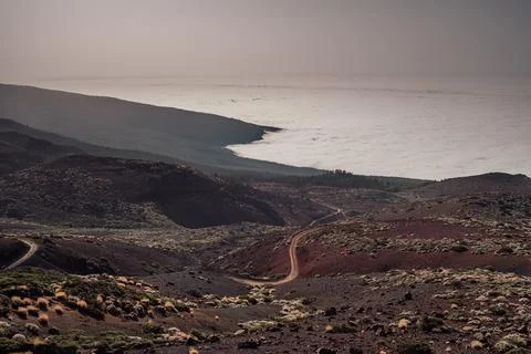 Observing the contrast between the clouds and earth from the mountains Stock Photos