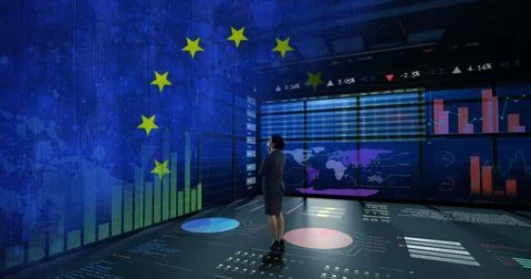 Observing executive in suit analyzing data in command center, with monitors, Foto stock