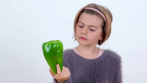 Observing a green pepper in her hand Stock Footage 83724725