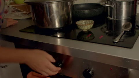 Observing hand signs around kitchen utensils in ambient lighting Stock Footage 325072876