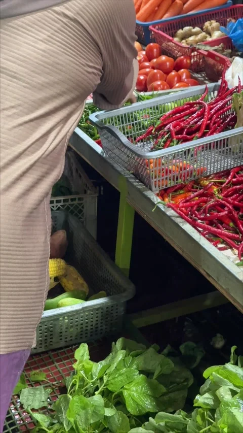 Observing the intricate process of choosing fresh, vibrant produce from a b.. Video stock 337284650