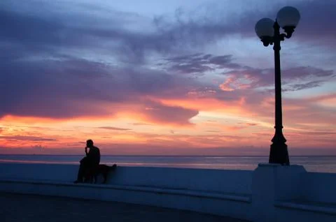 Observing the sunset over the sea Stock Photos