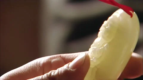 Observing the white jade pendant Stock Footage 316815262