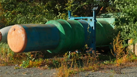 Obsolete, abandoned, and rusty combat missiles and shells stand amidst the .. Stock-Footage 345626156