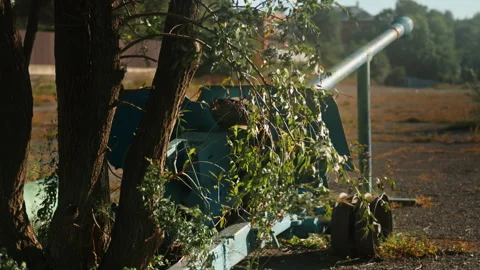 .Obsolete, abandoned, and rusty combat guns stand amidst the natural landsc.. Stock Footage 345627903