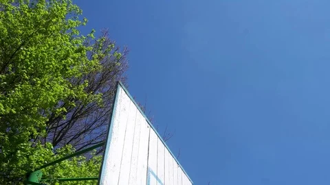 Obsolete Basketball hoop on blue sky background Video stock 75445853