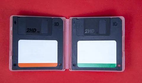 Obsolete computer floppy disks on a colored background, isolated, Stockfoto's