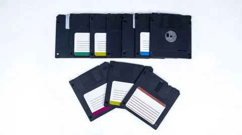 Obsolete computer floppy disks with a flash drive on a white background, Foto stock