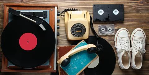 Obsolete objects on wooden background. Retro style, 80s, pop media 写真素材