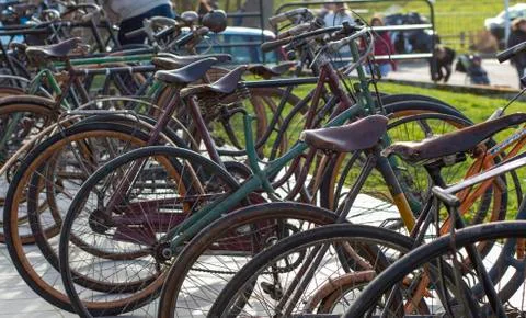 Obsolete old-fashioned bikes stand in a row Stock Photos