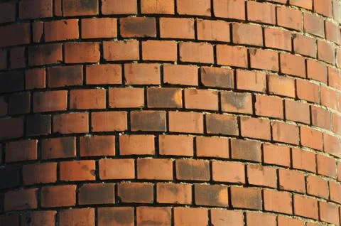The obsolete red-orange rounded brewing chimney built from bricks Stock Photos