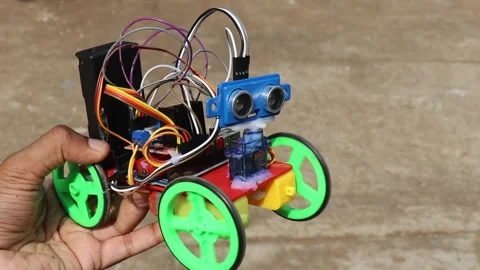 An obstacle avoidance robot car with ultrasonic sensor connected to a servo Stock Footage 282007552
