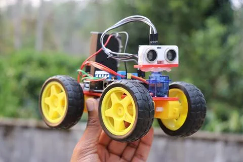 Obstacle avoiding car held in the hand. Robotic car Stock Photos