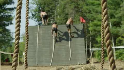 Obstacle course ropes slow motion men running Stock Footage 70572793