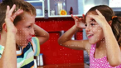Obstruction clearing students at kitchen table playing mirrored horn game, Video stock 321890103