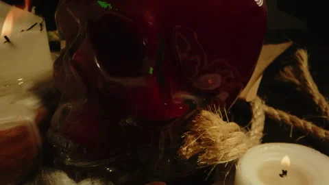 Occult concept: Eerie dolly out of a blood filled glass skull on the altar of a Stock Footage 336004677
