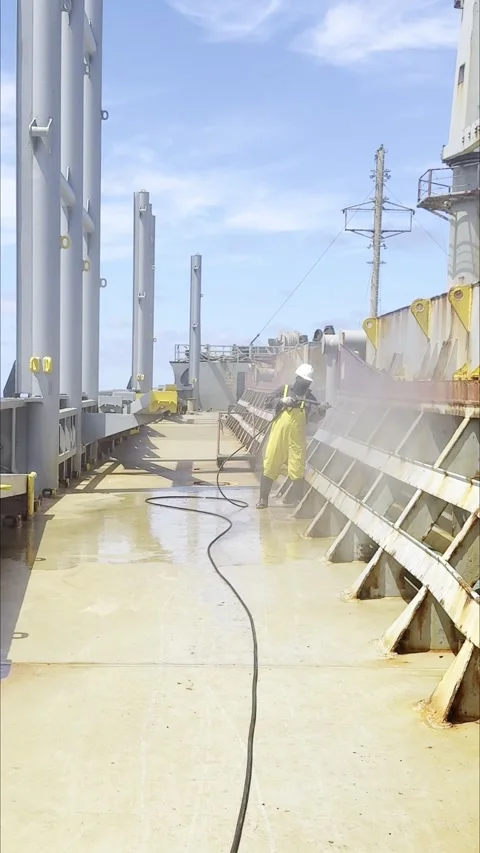 Occupational Safety: Crew Member Using Water Jet to Wash Ship Bulkheads Stock Footage 329250728