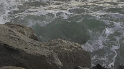 Ocean against rocks Stock Footage 33846857