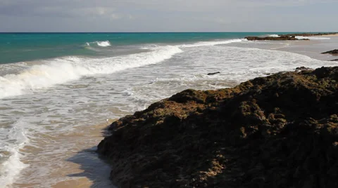 The ocean along a beach with rocks Stock Footage 39238364