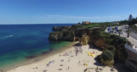 Ocean and beach near cliffs Lagos Portugal aerial view Stock Footage 64462196