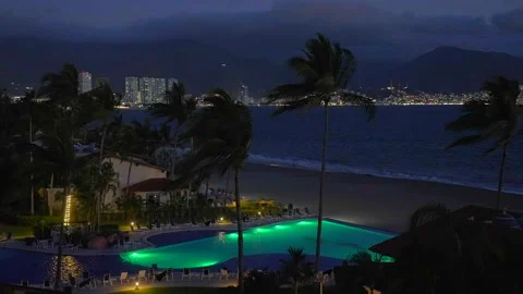 Ocean and resort pool at night in Puerto Vallarta, Mexico Stock Footage 276914842