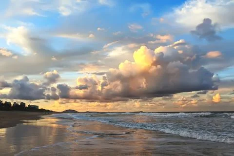 Ocean beach with cloudy sky in sunset. Australia, Sunshine Coast Stock Photos