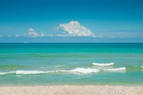 Ocean beach. Ocean background. Blue sky with white fluffy cloud. Atlantic Ocean Stock Photos