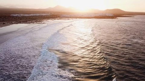 Ocean beach with rolling waves at sunset, aerial video from drone of Atlantic Stock Footage 105351936