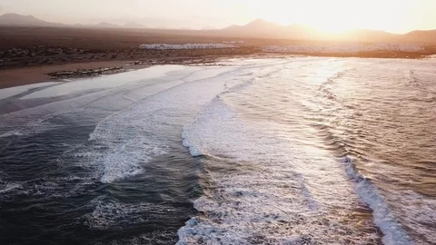 Ocean beach with rolling waves at sunset, aerial video from drone of Atlantic Stock Footage 105351938