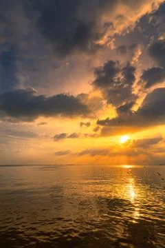 The ocean beach set with beautiful cloud and sun rays. Stock Photos