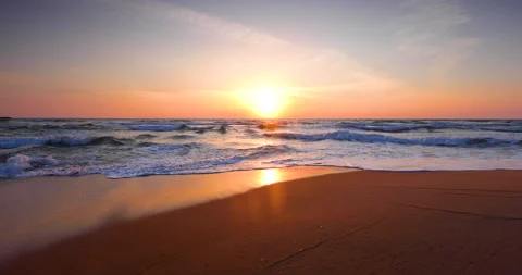 Ocean beach sunrise and dramatic colorful sky clouds, 4K Video Stock Footage 145098440