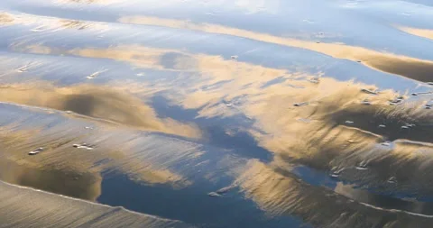 Ocean Beach Sunset Colors On Rippled Beach Sand Reflecting The Clouds And Waves Video stock 138070313