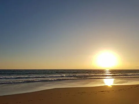 Ocean beach at sunset Stock Photos